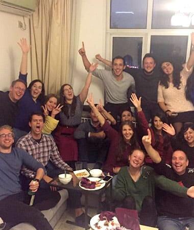 Large group of students in a living room at a social movie night