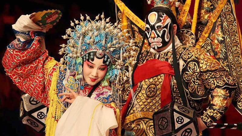 Two actors in masks performing Beijing opera