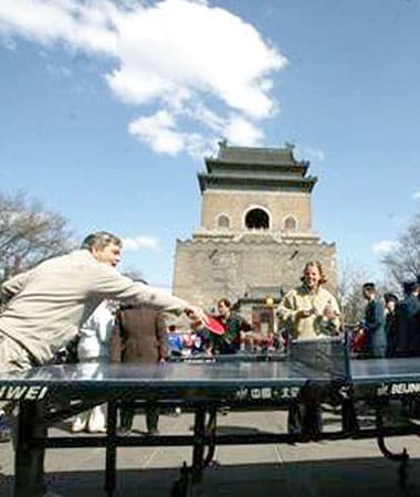 Two people playing ping pong outside in Beijing
